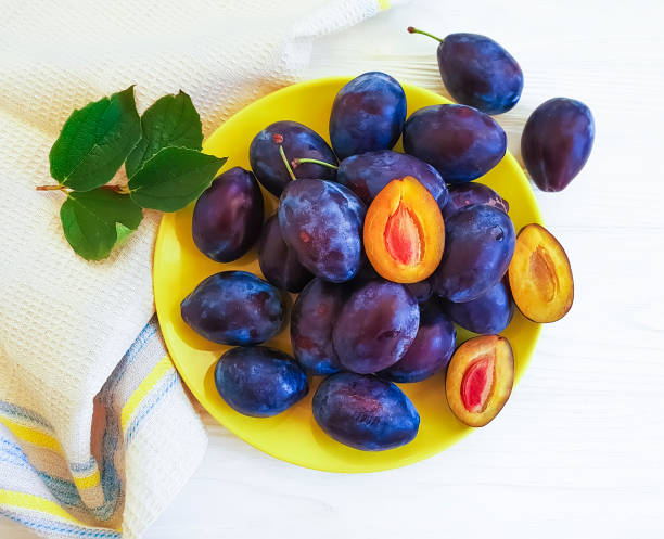 istock fresh organic plum on white wooden background 1038411536