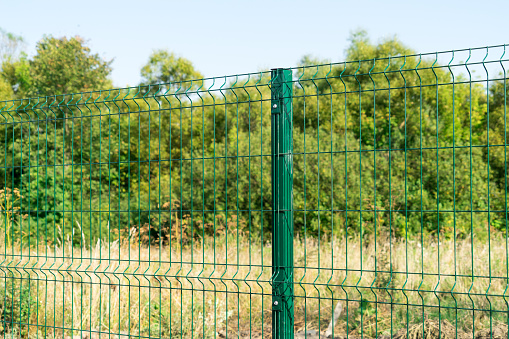 Mesh fence. Metal fence made of welded mesh.