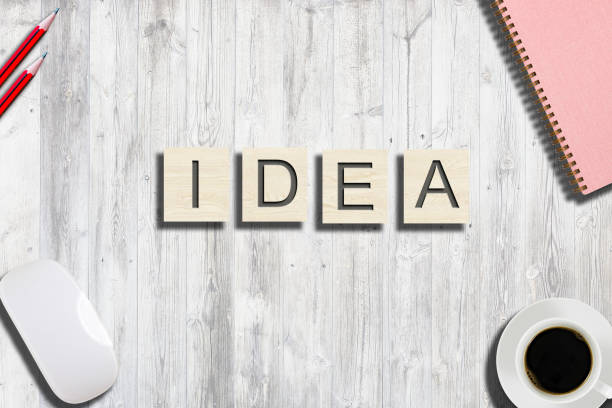 istock High angle view on business words made from wooden blocks on office table 1038442630