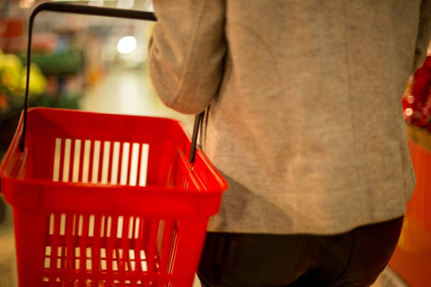 istock Hand holding empty shopping basket - Shopping concept 1038448290