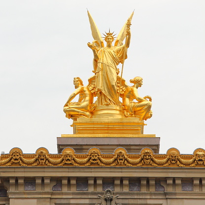 One of the statues on top of the Paris opera house, taken from the avenue.