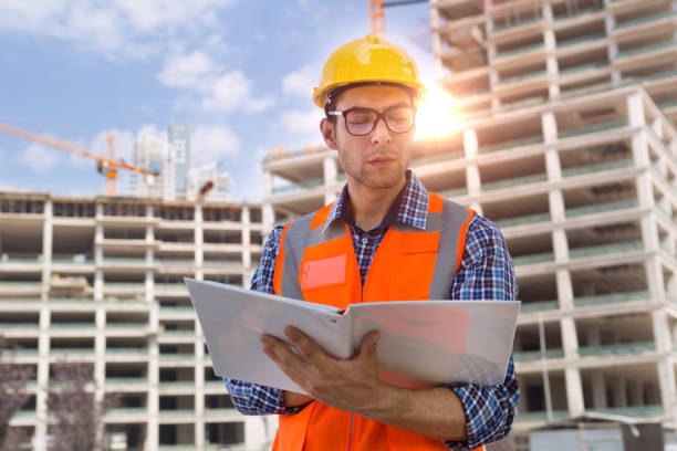 istock Young Engineer portrait with construction site and crane background. 1038458376