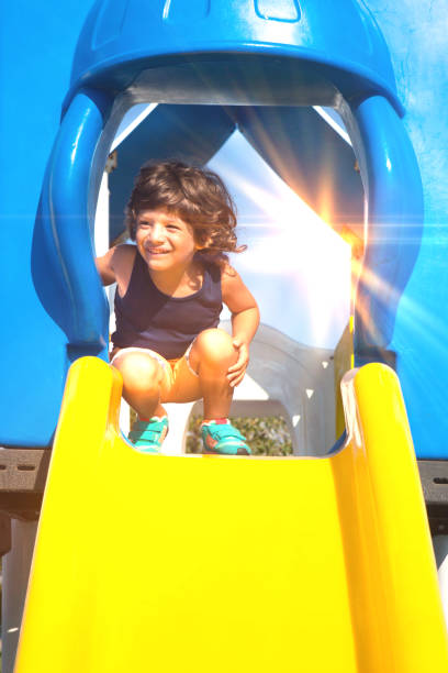 istock Excited little baby boy sliding down a slide. 1038462220
