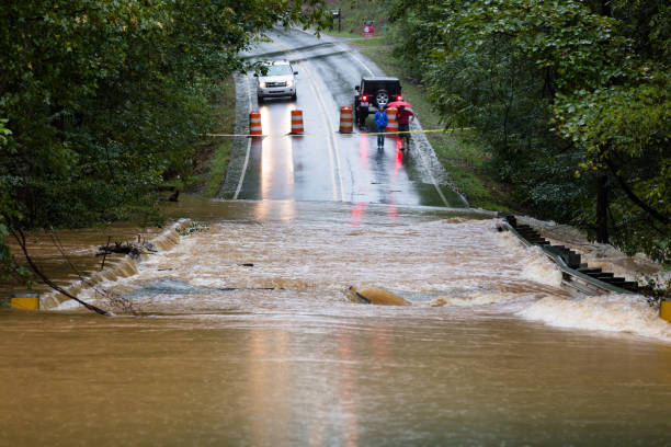 People in Union County, NC are blocked from crossing a road flooded by Hurricane Florence stock photo