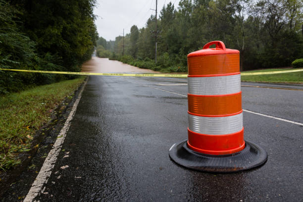 Police tape and a barricade block a flooded road Waxhaw, North Carolina - September 16, 2018: Police barricade the road after a bridge is washed out by rain from Hurricane Florence flood preparation stock pictures, royalty-free photos & images