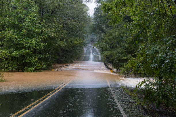Torrential rain floods a road stock photo