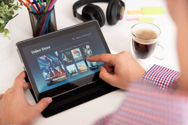 istock Man using digital tablet for watching movie on VOD service 1038491588
