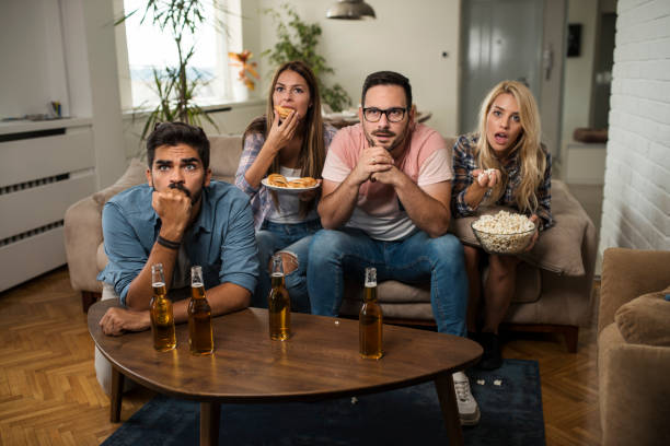 istock Friends watching sport on tv. 1038495922