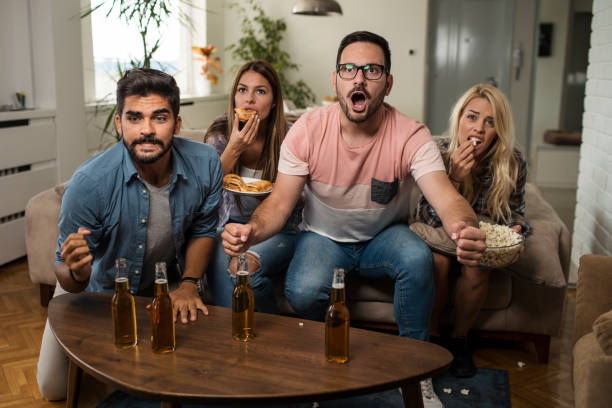 istock Friends watching sport on tv. 1038496922