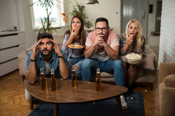 istock Friends watching sport on tv. 1038496932