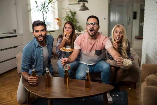 istock Friends watching sport on tv. 1038499014