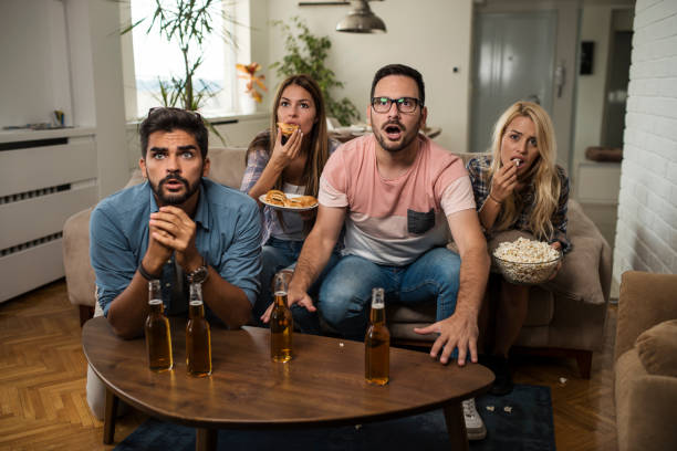 istock Friends watching sport on tv. 1038499294