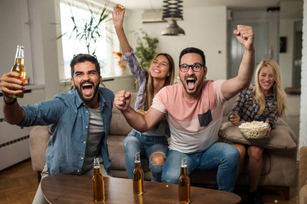 istock Friends watching sport on tv. 1038499566