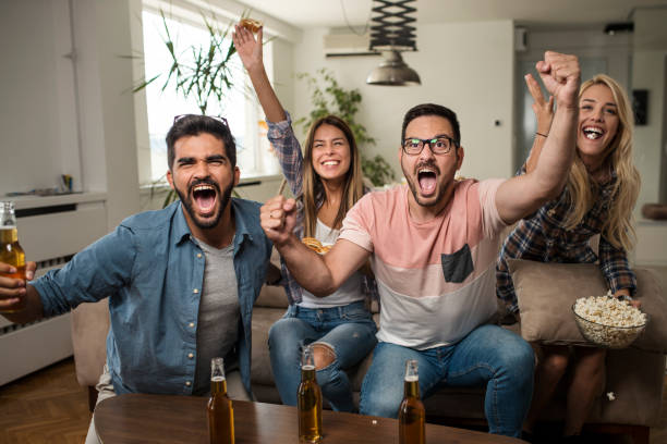 istock Friends watching sport on tv. 1038499574