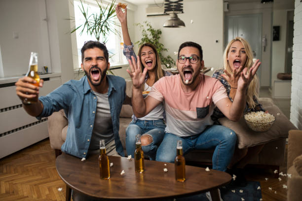 istock Friends watching sport on tv. 1038499810