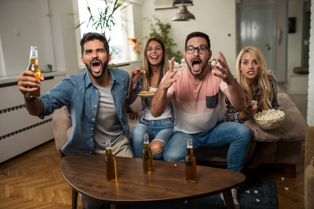 istock Friends watching sport on tv. 1038499844