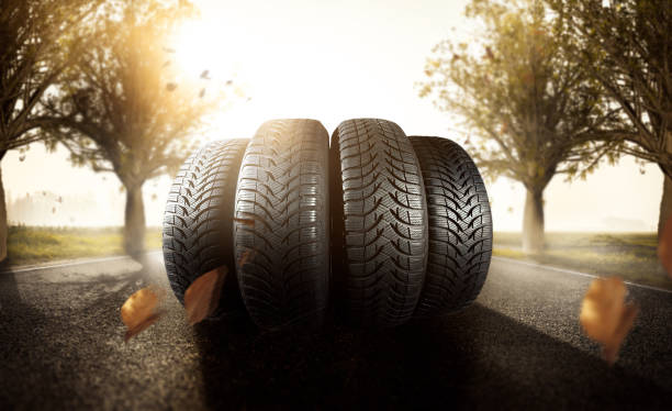 Car tire on an autumn road stock photo