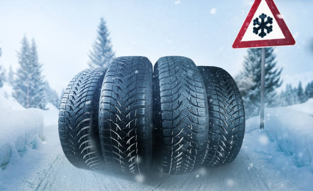 istock Car tires on a snow covered roadway 1038556996