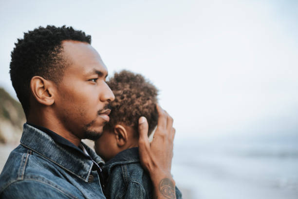 Serious dad with his son outdoors Serious dad with his son outdoors single father stock pictures, royalty-free photos & images