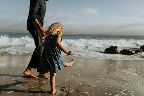 istock Father and daughter at a beach 1038578238