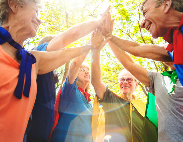 istock Childlike seniors superheroes giving a high five 1038583980