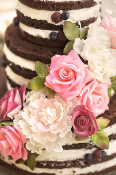 istock Wedding rustic naked cake layered with flowers and berries 1038596802