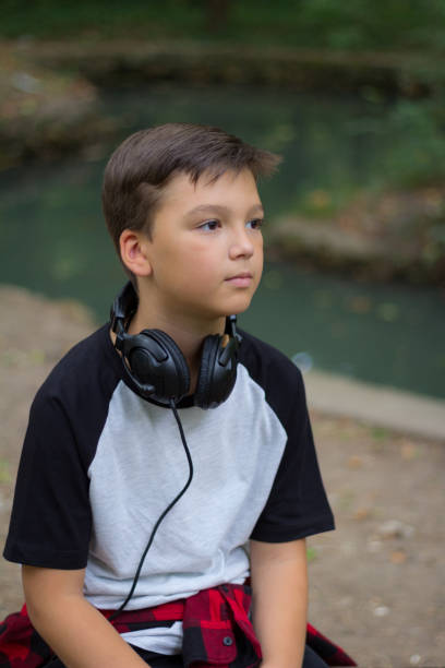 istock A beautiful boy with his headphones around his neck 1038602736