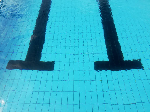 istock blue swimming pool background, with black lane 1038629090