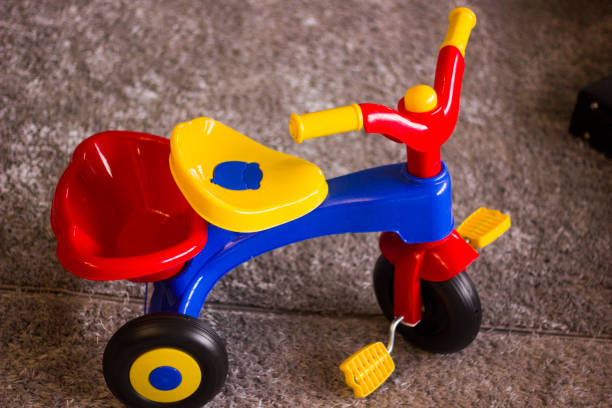 kids tricycle on grey carpet