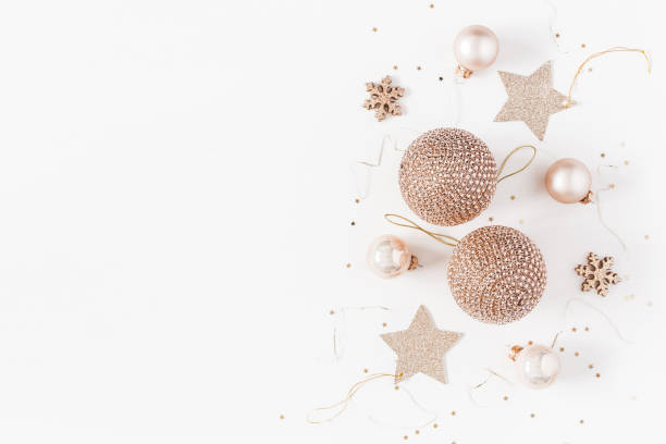 Christmas composition. Christmas balls, golden decorations on white background. Flat lay, top view, copy space