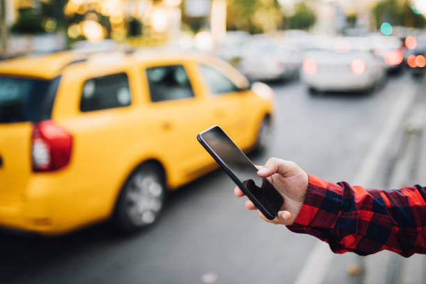 istock Smart phone with yellow cab in background 1038637154