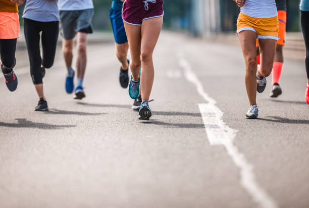 istock Unrecognizable athletic people running a marathon on the road. 1038638390
