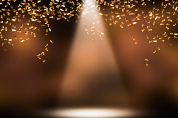 festive shower of golden confetti shower of golden confetti on festive stage headlight photos stock pictures, royalty-free photos & images