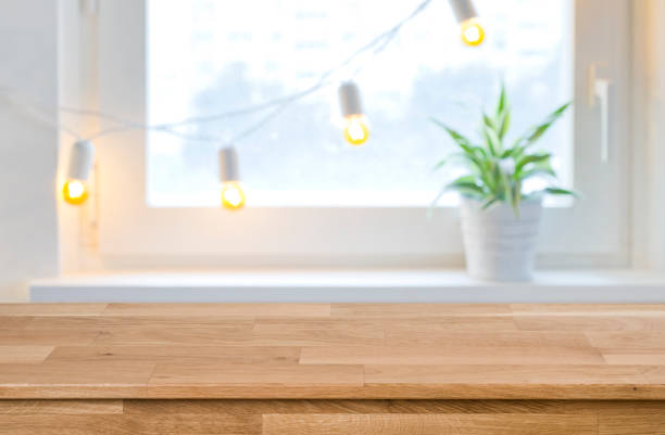 istock Wooden empty board in front of blurred holiday window background 1038658222