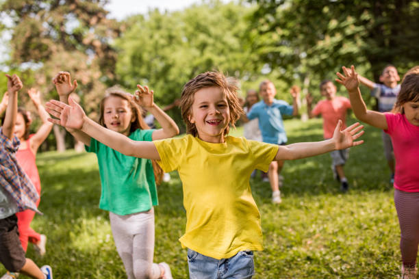 istock Carefree children having fun while running in spring day at the park. 1038661576