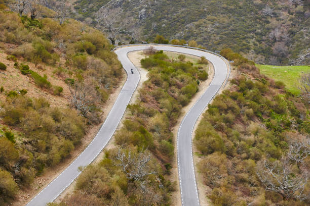istock Motorcycle on a curved asphalt mountain road. Travel 1038661584