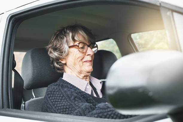 istock Smiling senior woman drives her car 1038665064