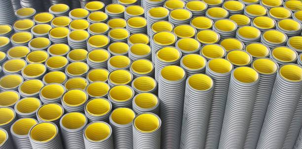 istock Stack of black  yellow corrugated plastic pipes 1038671144