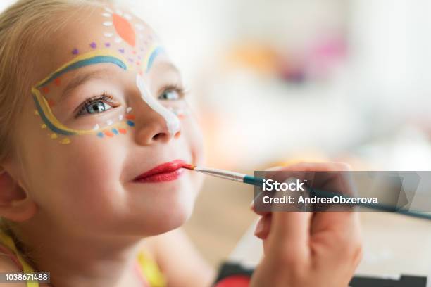 Cute Little Girl Having Her Face Painted For Halloween Party Halloween Or Carnival Family Lifestyle Background Face Painting Headshot Close Up Stock Photo - Download Image Now