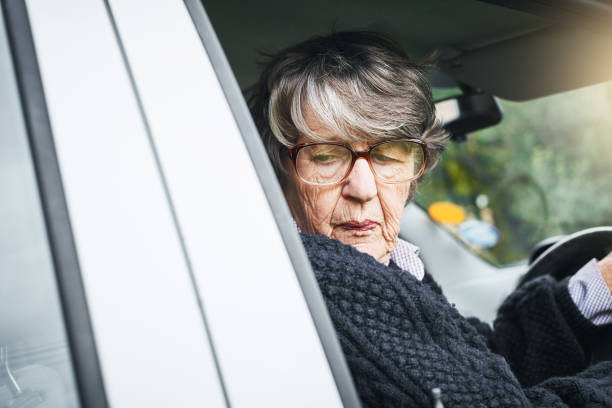 istock Senior woman concentrates on reversing her car 1038674880