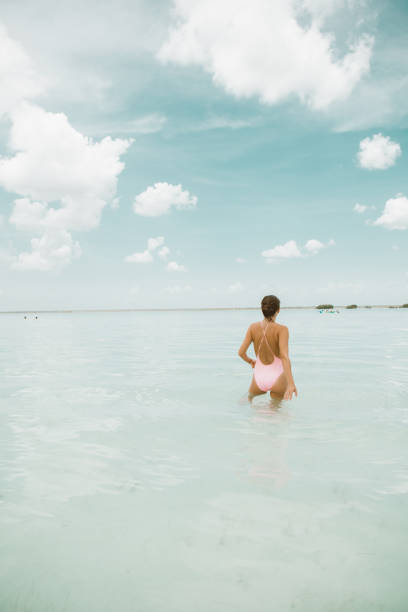 istock Woman walking in a lagoon 1038678992