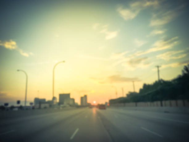 istock Filtered tone blurry background usual traffic condition on highway interstate at sunrise in USA 1038679884