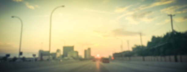 istock Panoramic blurry background usual traffic condition on highway interstate at sunrise in USA 1038679958