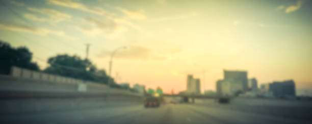 istock Panoramic blurry background usual traffic condition on highway interstate at sunrise in USA 1038680182