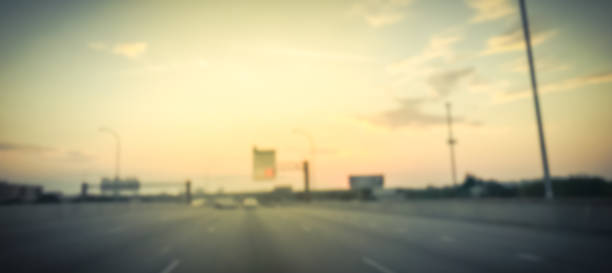 istock Panoramic blurry background usual traffic condition on highway interstate at sunrise in USA 1038684372