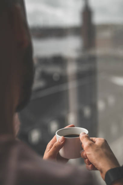 istock A man drinking coffee in the window 1038684386