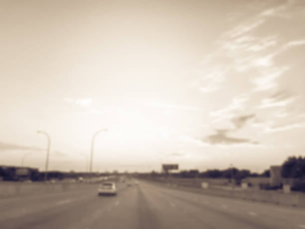 istock Filtered tone blurry background usual traffic condition on highway interstate at sunrise in USA 1038684492