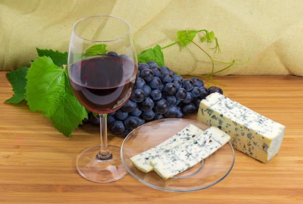 istock Red wine against of blue grapes and blue cheese 1038685380