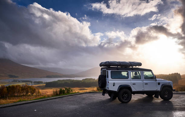 Land Rover defender with roof tent to Glen Etive, Scottish Highlands during sunset Land Rover defender with roof tent on the way to Glen Etive, Scottish Highlands during sunset glen etive photos stock pictures, royalty-free photos & images