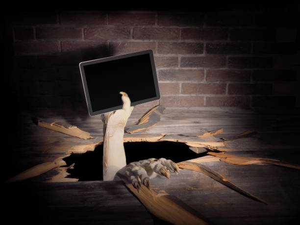 istock Zombie hand through hole cracked in rustic wood.Halloween theme 1038691518